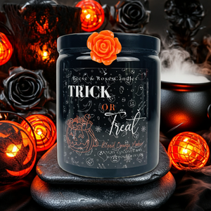 Halloween-themed candle with decorative elements on a dark background