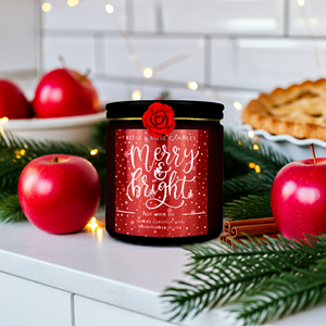 Candle with 'Merry & Bright' label on a festive background with apples, cinnamon, and pie.