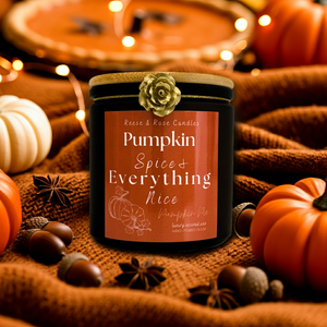 Candle labeled 'Pumpkin Spice & Everything Nice' surrounded by pumpkins and autumn decorations.